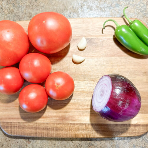 Tomatoes, garlic, jalapenos, and an onion for making homemade salsa