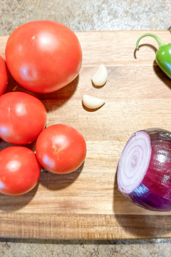 Tomatoes, garlic, jalapenos, and an onion for making homemade salsa