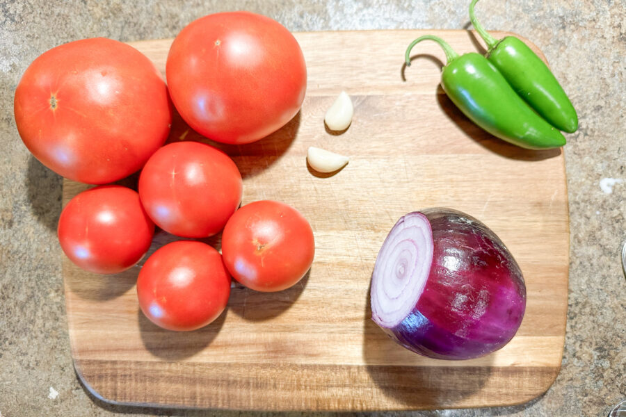 Tomatoes, garlic, jalapenos, and an onion for making homemade salsa